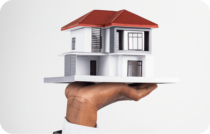 Model house held in an outstretched hand